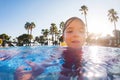 Girl learning to swim in the pool during summer vacation. Beach resort vacation by sea. Winter or summer seaside resort Royalty Free Stock Photo