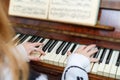 The girl learns to play the piano at the lessons at the music school. Royalty Free Stock Photo