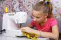 Girl learns to sew Royalty Free Stock Photo