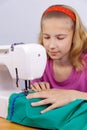 Girl learns to sew Royalty Free Stock Photo