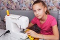 Girl learns to sew on an sewing machine Royalty Free Stock Photo