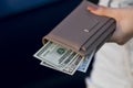 Girl with leather wallet full of money Royalty Free Stock Photo