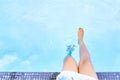 Girl legs in the blue swimming pool,   Summer holiday concept Royalty Free Stock Photo