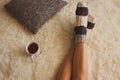 Girl legs in warm woolen socks with teacup and pillow, top view. Woman on white carpet with cup of tea with lemon. Royalty Free Stock Photo