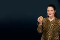 girl in a leopard blouse with a hamburger in her hand. Empty space on the left