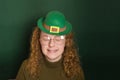 girl in a leprechaun hat on a green background Royalty Free Stock Photo