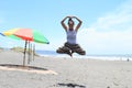 Girl levitating in yoga pose on beach