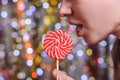 A girl licks a lollipop