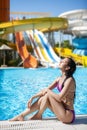 Girl lies on the backdrop of water slides. Royalty Free Stock Photo