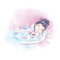 The girl lies in a bath with aromatic oils and salt.