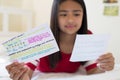 Girl Lying On Bed Using Written Study Cards To Help With Revision Royalty Free Stock Photo