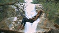 Girl Lies on Hammock against Pictorial Waterfall