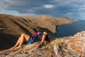 The girl lies on a rock above the lake. Royalty Free Stock Photo