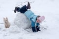 Girl lies on snowdrift head over heels