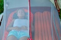 Girl lies in a tent with no outside awning on the sleeping mat