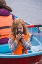 Girl life jacket, a child in a boat, says on the radio