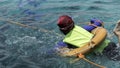 A girl with a life jacket and swimming