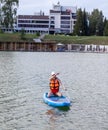 SUP board up paddle girl boarding on lake standing happy on water Royalty Free Stock Photo