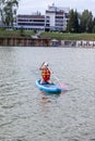 SUP board up paddle girl boarding on lake standing happy on water Royalty Free Stock Photo