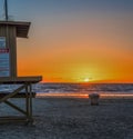 girl on a lifeguard tower in Newport Beach at sunset Royalty Free Stock Photo