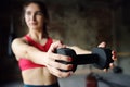 Girl lifting dumbbells in gym during workout. Young woman doing fitness. Regular sports boosts immune system and promote good