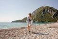 Girl in the light dress walking on the beach Royalty Free Stock Photo