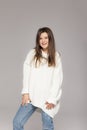 Girl in light jeans and a white oversized sweater