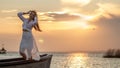 A girl stands in a boat and basks in the sunset. Text space