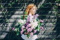 Girl with a lilac bouquet of lilac in the garden. girl tearing the lilac in the garden