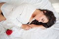 Girl in lingerie lying on a bed with a rose Royalty Free Stock Photo