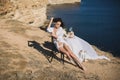 Girl in lingerie on top of a mountain overlooking the ocean. Charges of the bride, bride`s morning. Royalty Free Stock Photo