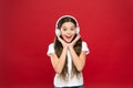 Girl listen music headphones on red background. Play list concept. Music taste. Music plays an important part lives
