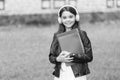 Girl listening audio carry textbooks on way to school, language lessons concept