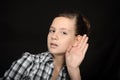 Girl listening with her hand on an ear Royalty Free Stock Photo