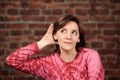 Girl listening with her hand on an ear Royalty Free Stock Photo