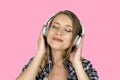 Girl listening music in headphones isolated pink background Royalty Free Stock Photo