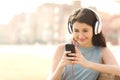 Girl listening music with headphones from a smart phone Royalty Free Stock Photo