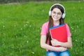 Girl listening summer melody wireless headphones nature background, back to school concept