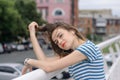 Girl listening to music in the background of a megacity