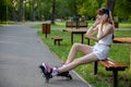 Girl listening to music on headphones in the park Royalty Free Stock Photo