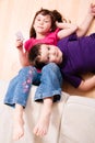 Children chilling on a the floor Royalty Free Stock Photo