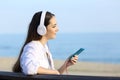 Girl listening to music relaxing on the beach Royalty Free Stock Photo