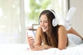 Girl listening to music from a smartphone at home