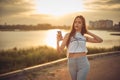 Girl listening to music with smartphone walking in the city with headphones smiling - relax, youth, emancipation concept Royalty Free Stock Photo