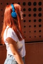 Girl listening to music on street in headphones Royalty Free Stock Photo