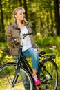 Girl listens music on a bicycle outdoors Royalty Free Stock Photo