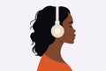 Girl listens to music in headphones. Profile of a young African woman. Podcast, audiobook, radio, meditation concept