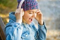 Girl listens to music in headphones. Smiling girl relaxing, music a smartphone and headphones. Outdoors portrait of a Royalty Free Stock Photo