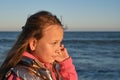 a girl listens to a seashell on the beach Royalty Free Stock Photo