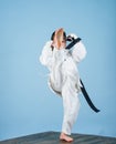 Girl little child in white kimono with belt. Karate fighter ready to fight. Karate sport concept. Self defence skills